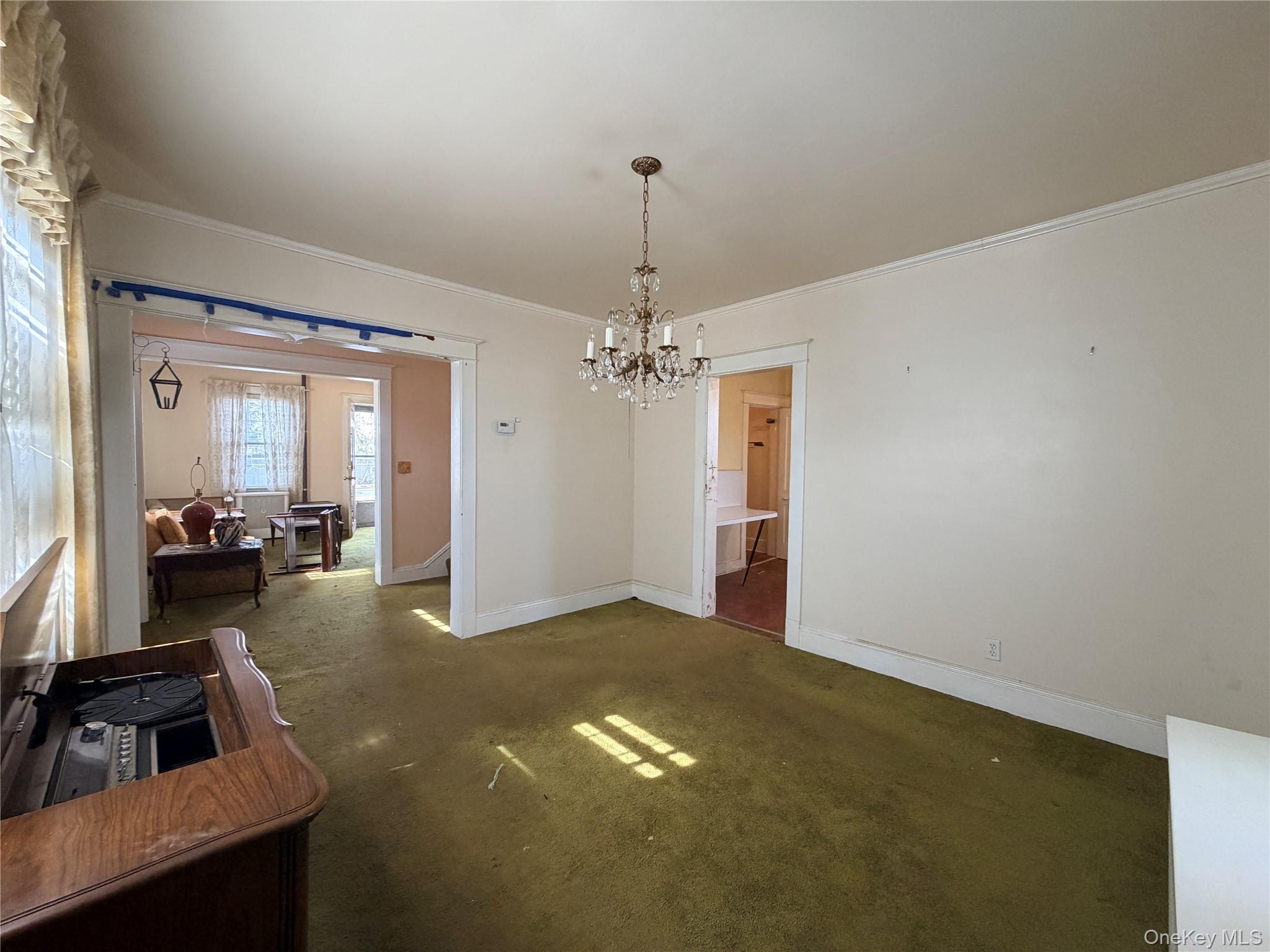 245 Woodbury Road Hicksville, NY 11801 - Photo 14 of 37 a view of a livingroom with a chandelier furniture and windows