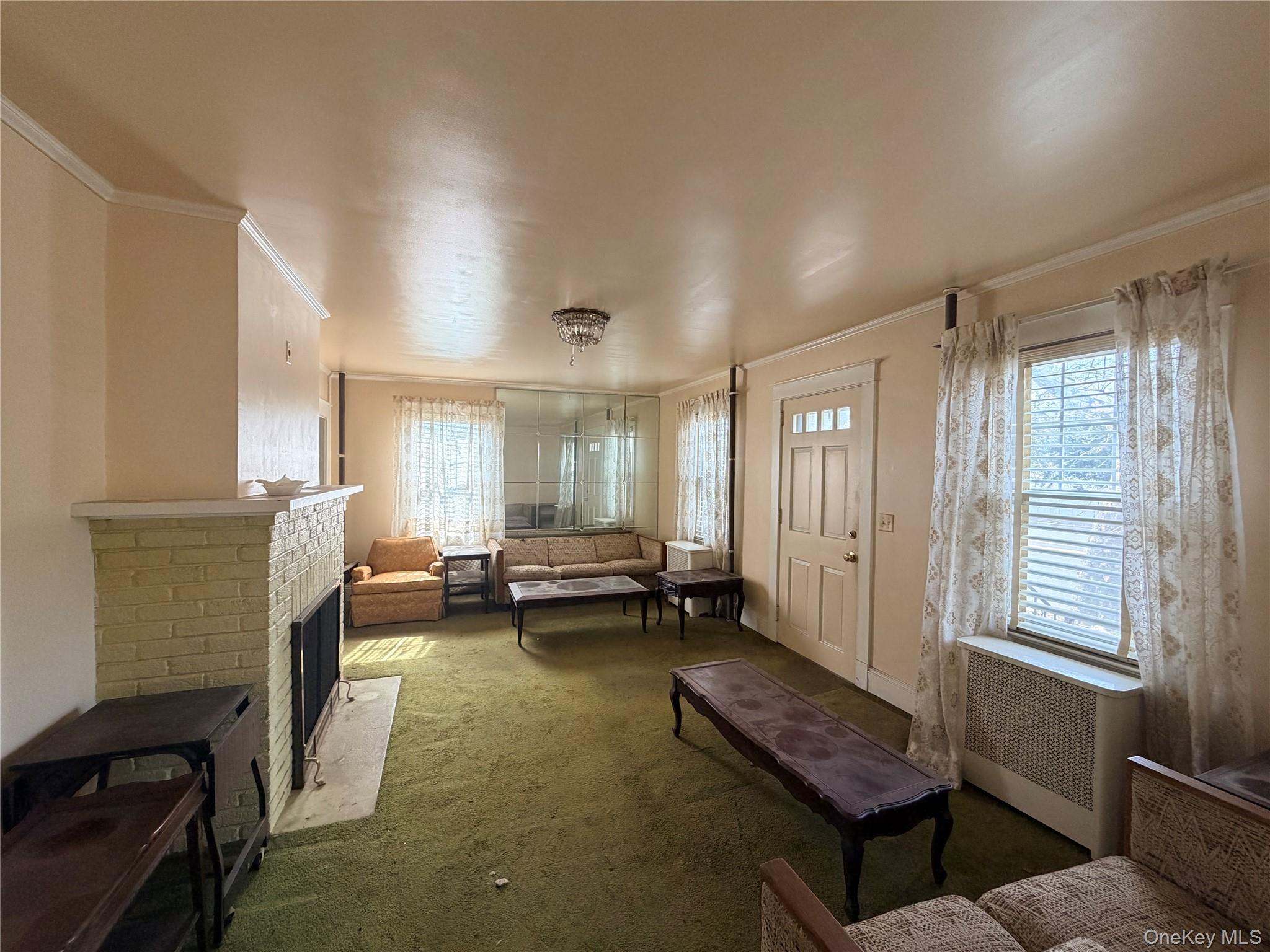245 Woodbury Road Hicksville, NY 11801 - Photo 16 of 37 a living room with furniture and a window