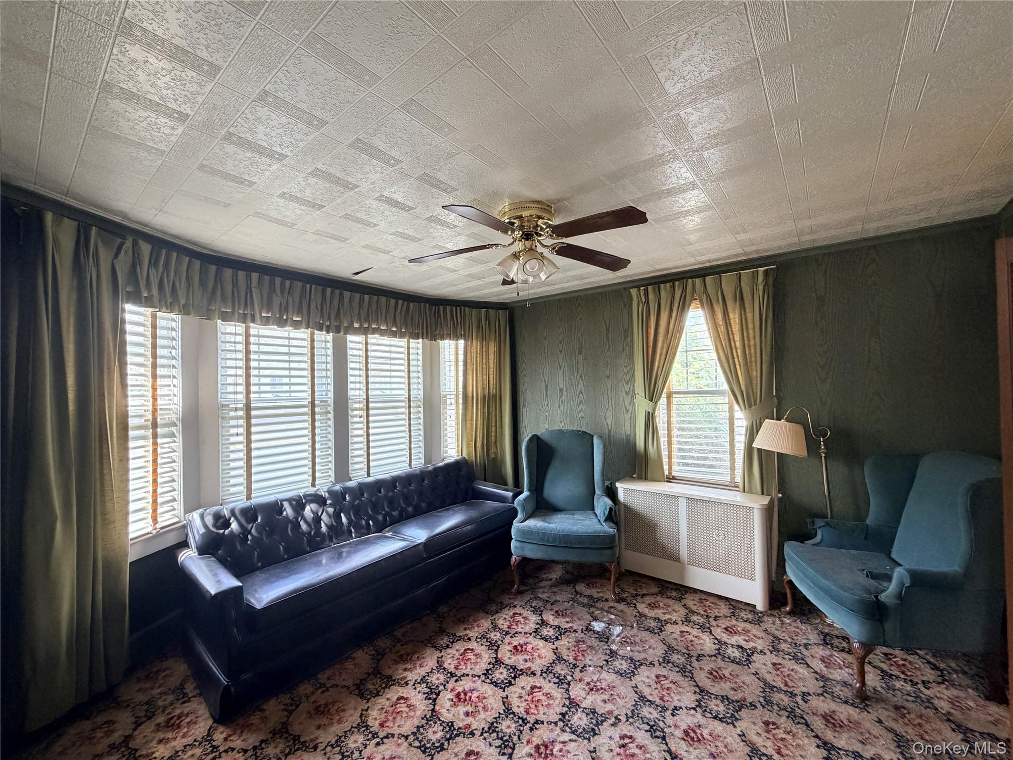 245 Woodbury Road Hicksville, NY 11801 - Photo 17 of 37 a living room with furniture and a large window