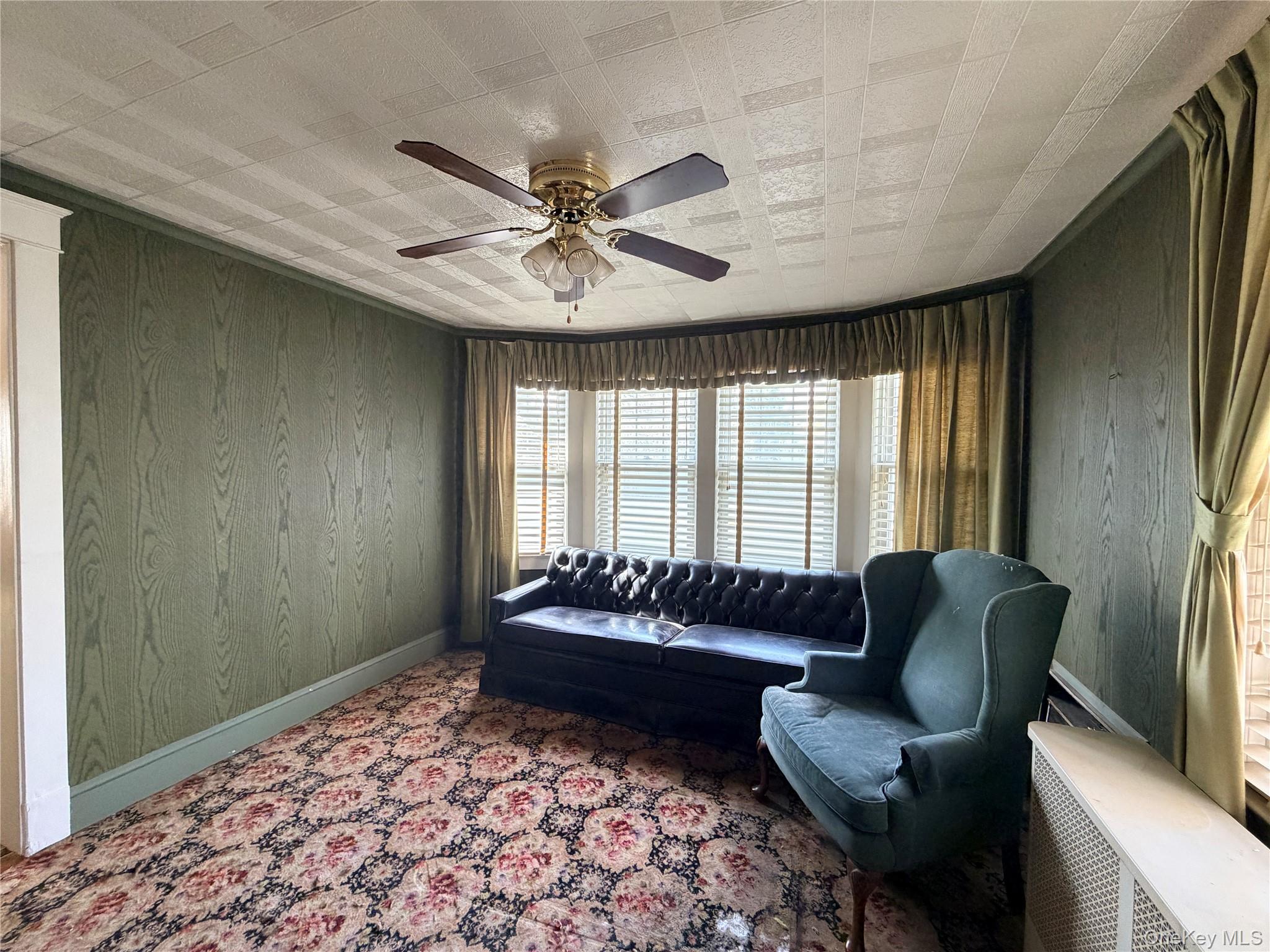 245 Woodbury Road Hicksville, NY 11801 - Photo 18 of 37 a living room with furniture and a large window