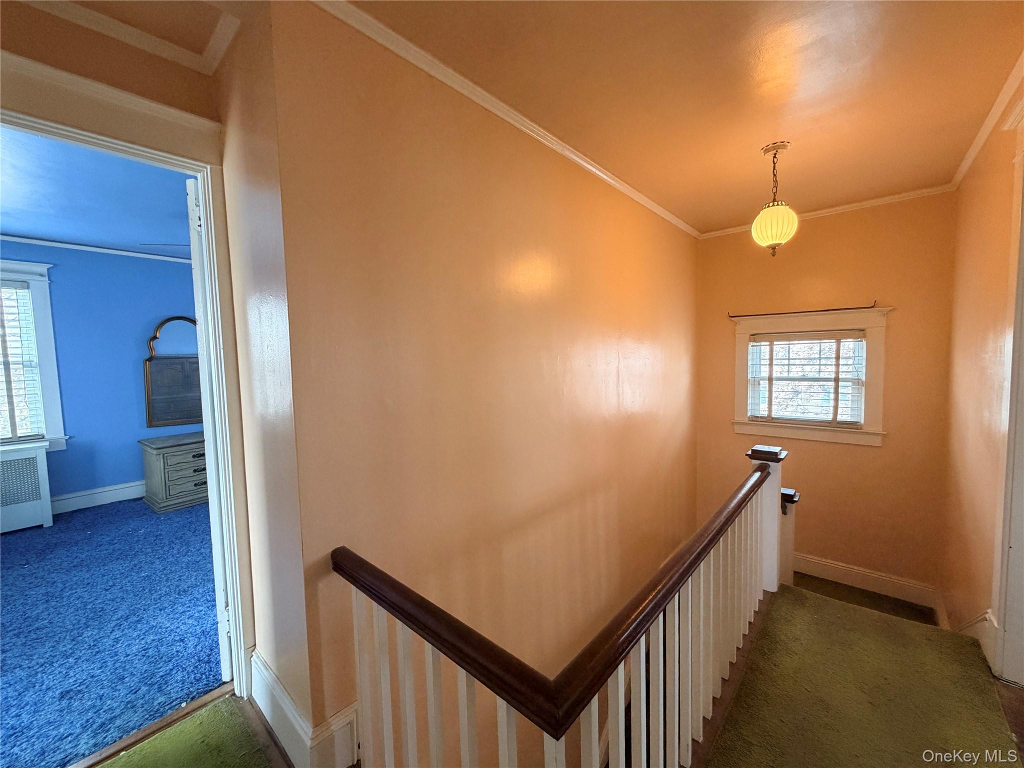 245 Woodbury Road Hicksville, NY 11801 - Photo 24 of 37 a view of a hallway with wooden floor and stairs