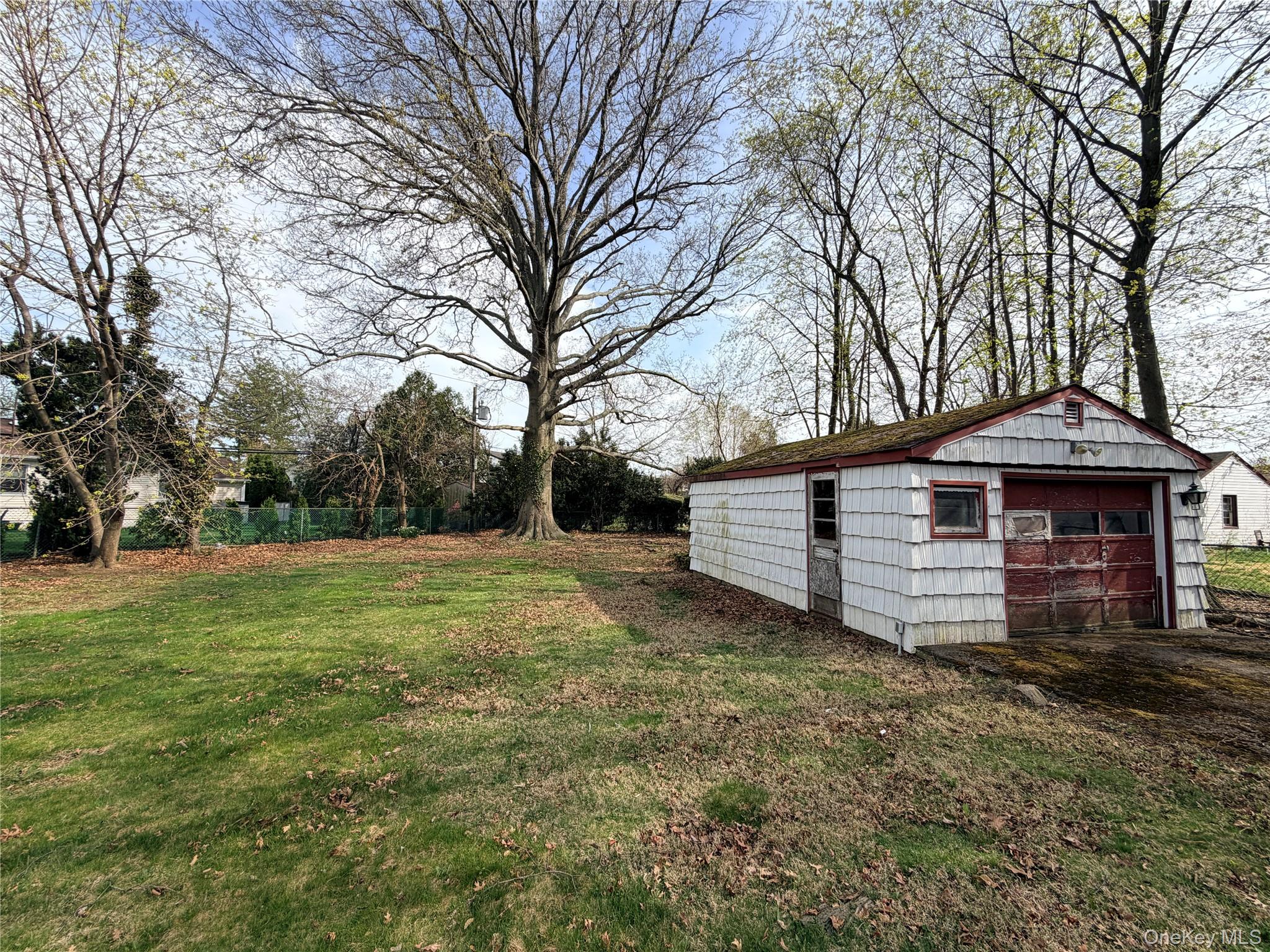 245 Woodbury Road Hicksville, NY 11801 - Photo 35 of 37 a view of a house with a yard