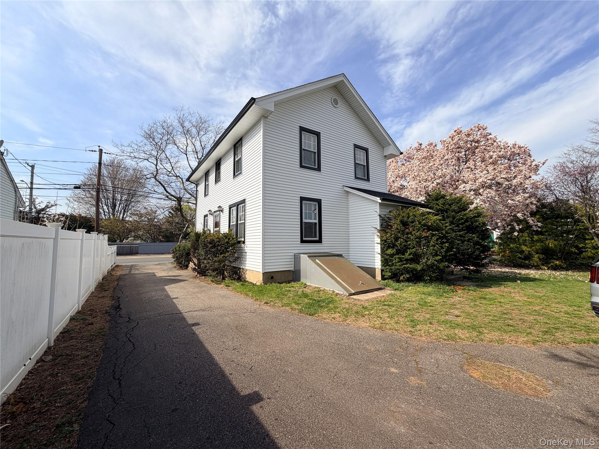 245 Woodbury Road Hicksville, NY 11801 - Photo 36 of 37 a view of a house with a yard