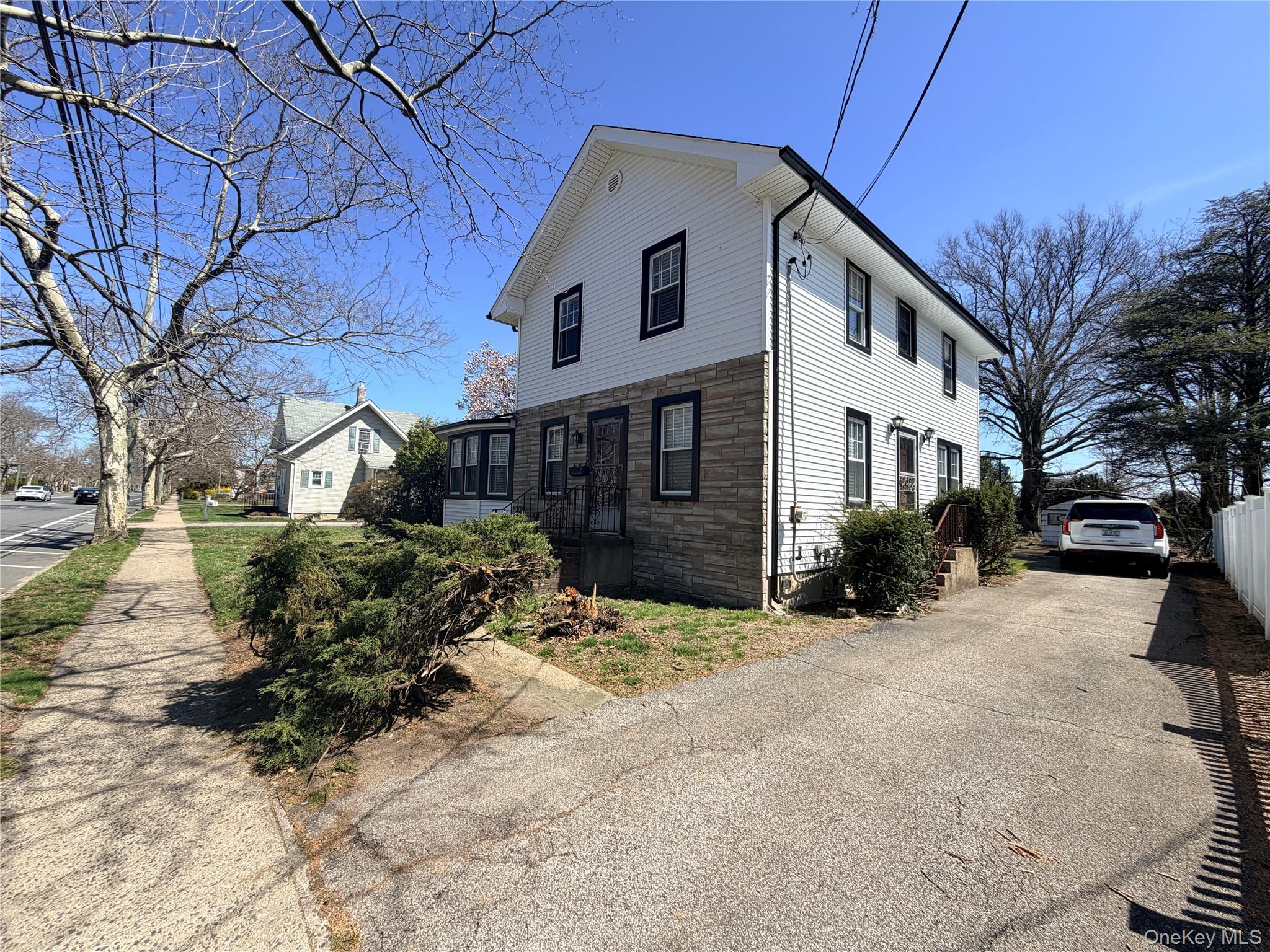 245 Woodbury Road Hicksville, NY 11801 - Photo 5 of 37 a front view of a house with a yard