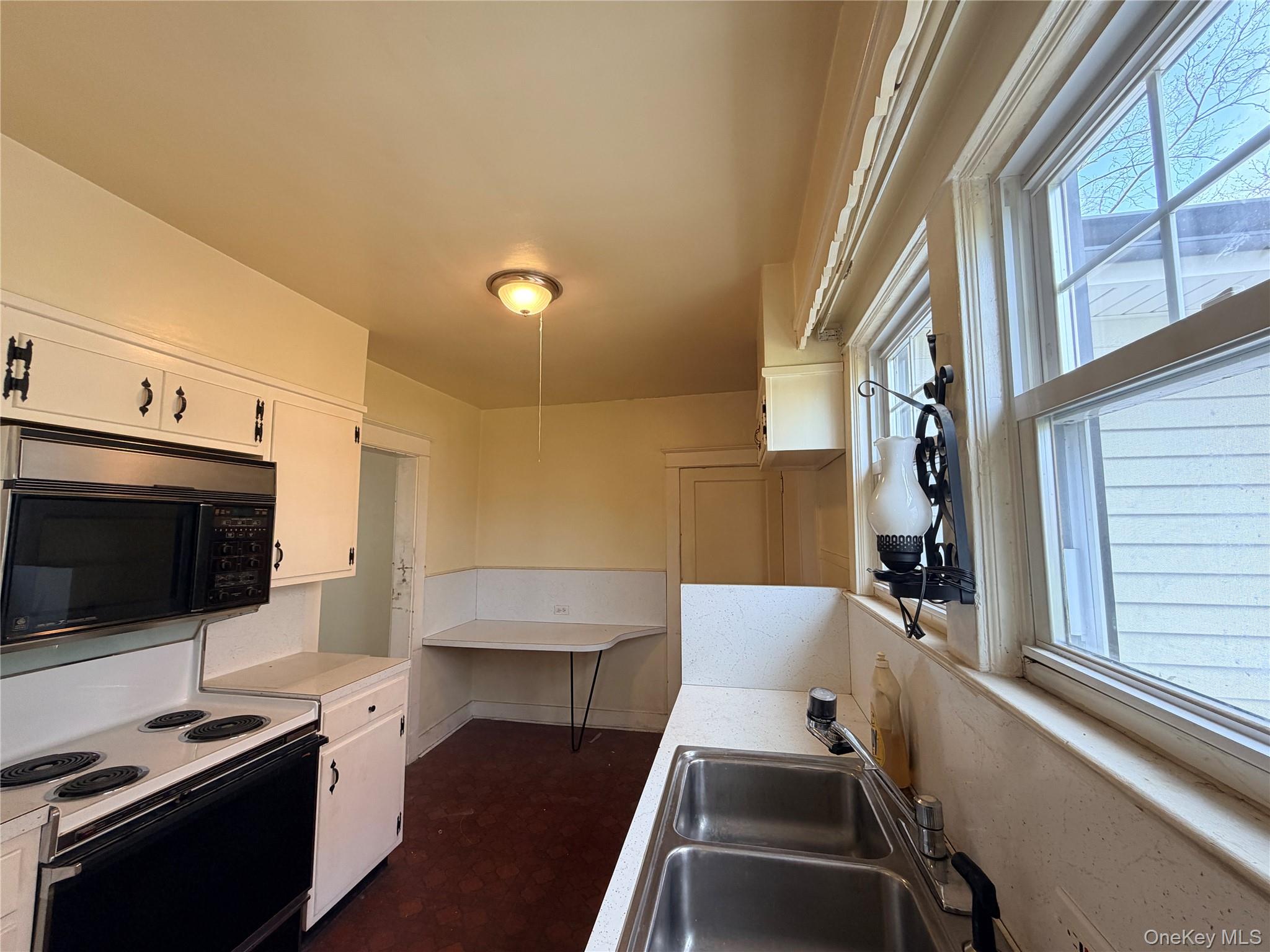 245 Woodbury Road Hicksville, NY 11801 - Photo 8 of 37 a living room with furniture and a flat screen tv