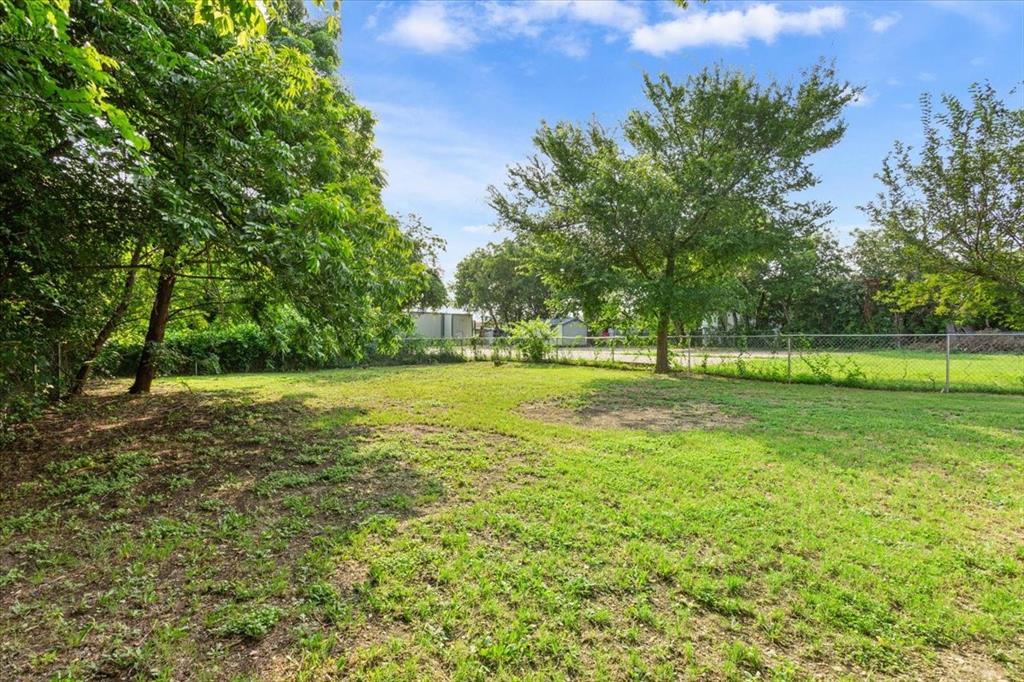 3109 North 20th Street Waco, TX 76708 - Photo 24 of 24 Expansive outdoor area featuring mature trees and a chain-link fence