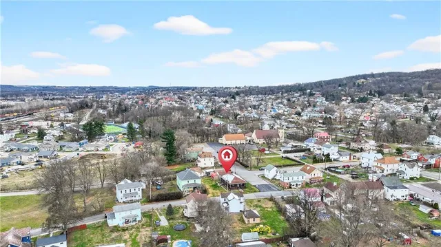 a kitchen with white cabinets and sink