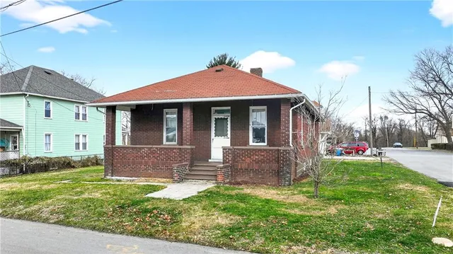 a front view of house with yard and outdoor seating