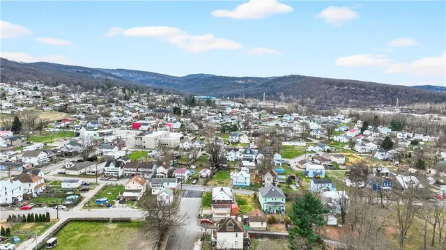a view of a bedroom with wooden floor and window