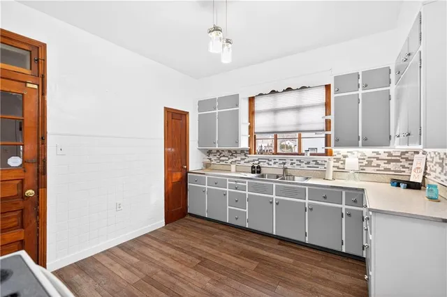 a view of a bedroom with a bed and a chandelier fan