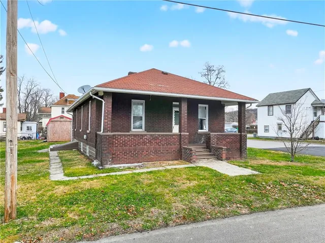 a front view of house with yard and porch