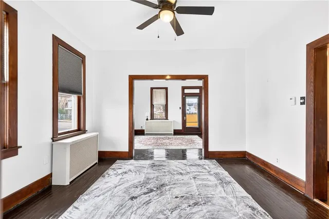 a view of a hallway with wooden floor and closet