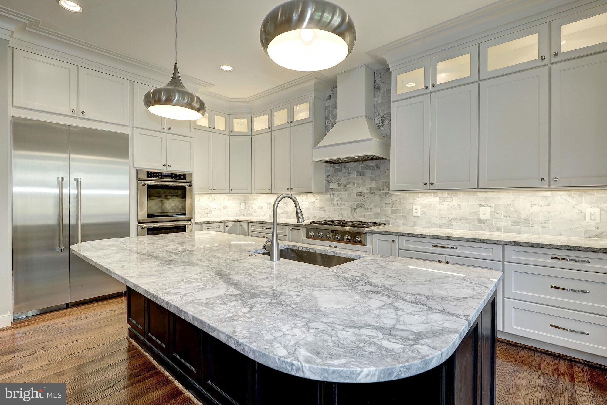 2108 Windsor Road Alexandria, VA 22307 - Photo 11 of 30 a kitchen with kitchen island granite countertop a sink a center island cabinets and stainless steel appliances