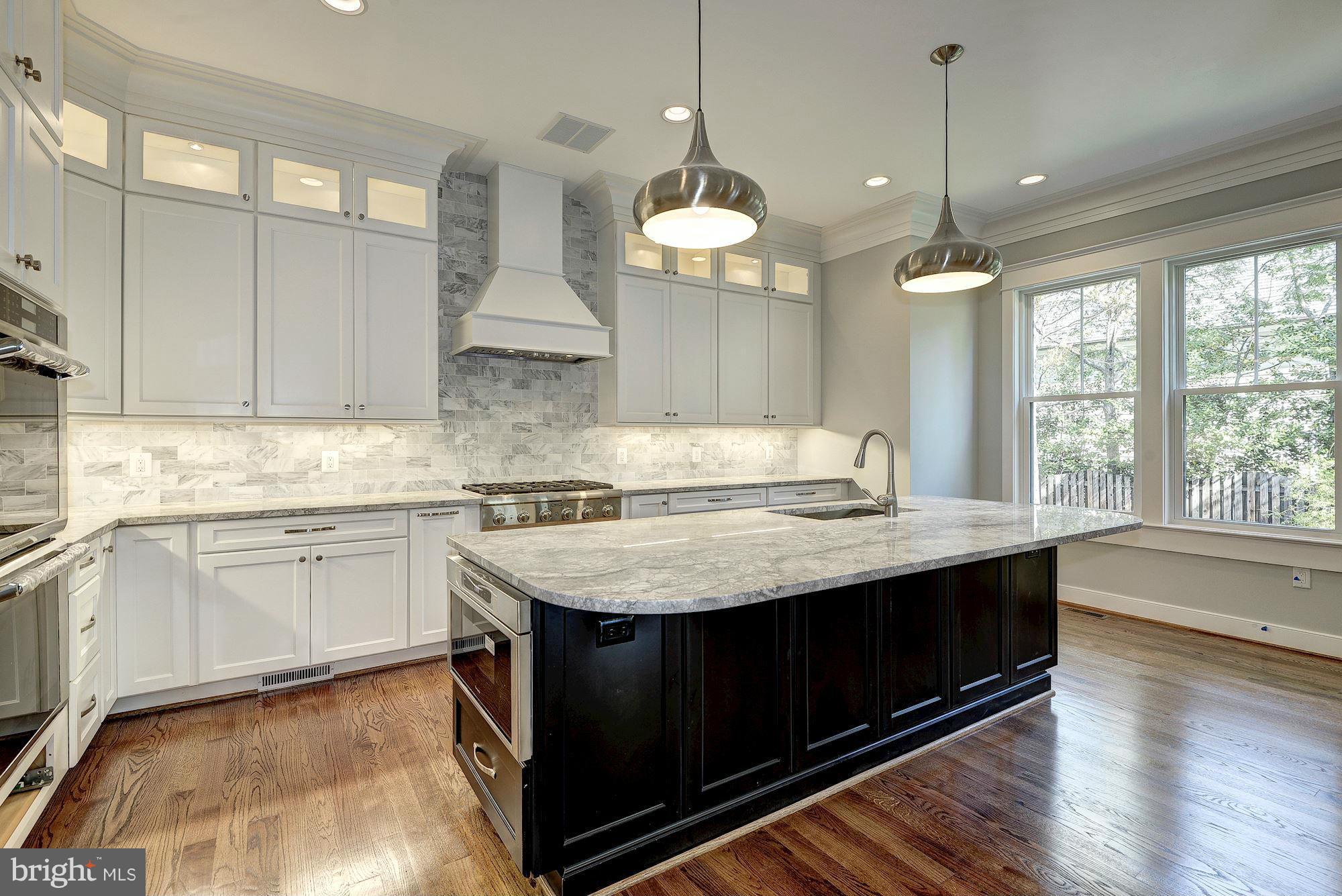 2108 Windsor Road Alexandria, VA 22307 - Photo 12 of 30 a kitchen with granite countertop a sink cabinets and wooden floor