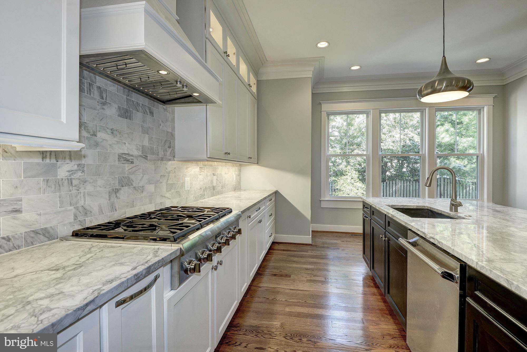2108 Windsor Road Alexandria, VA 22307 - Photo 13 of 30 a kitchen with granite countertop a sink stove and cabinets