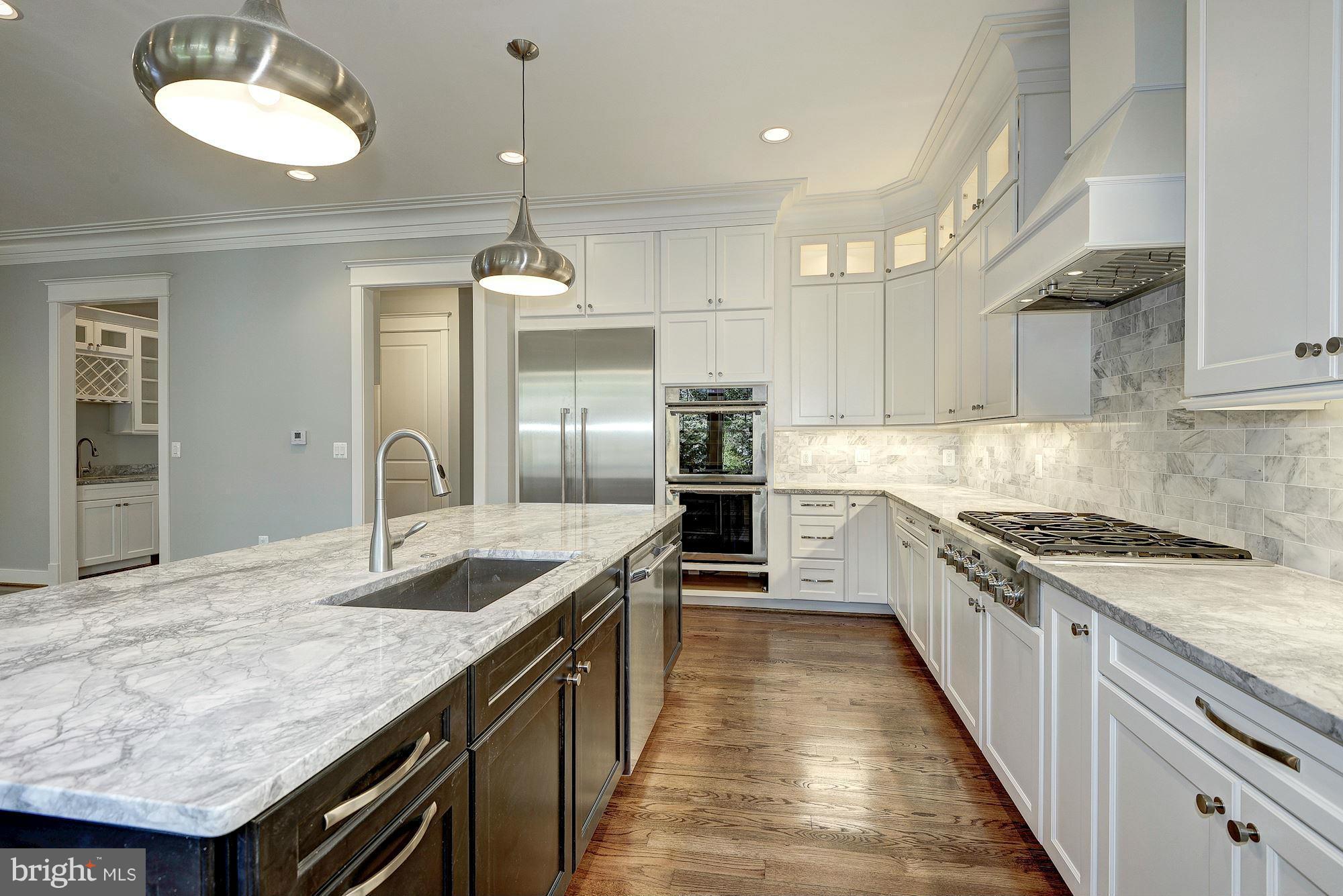 2108 Windsor Road Alexandria, VA 22307 - Photo 14 of 30 a kitchen with granite countertop kitchen island a counter space a sink stainless steel appliances and cabinets