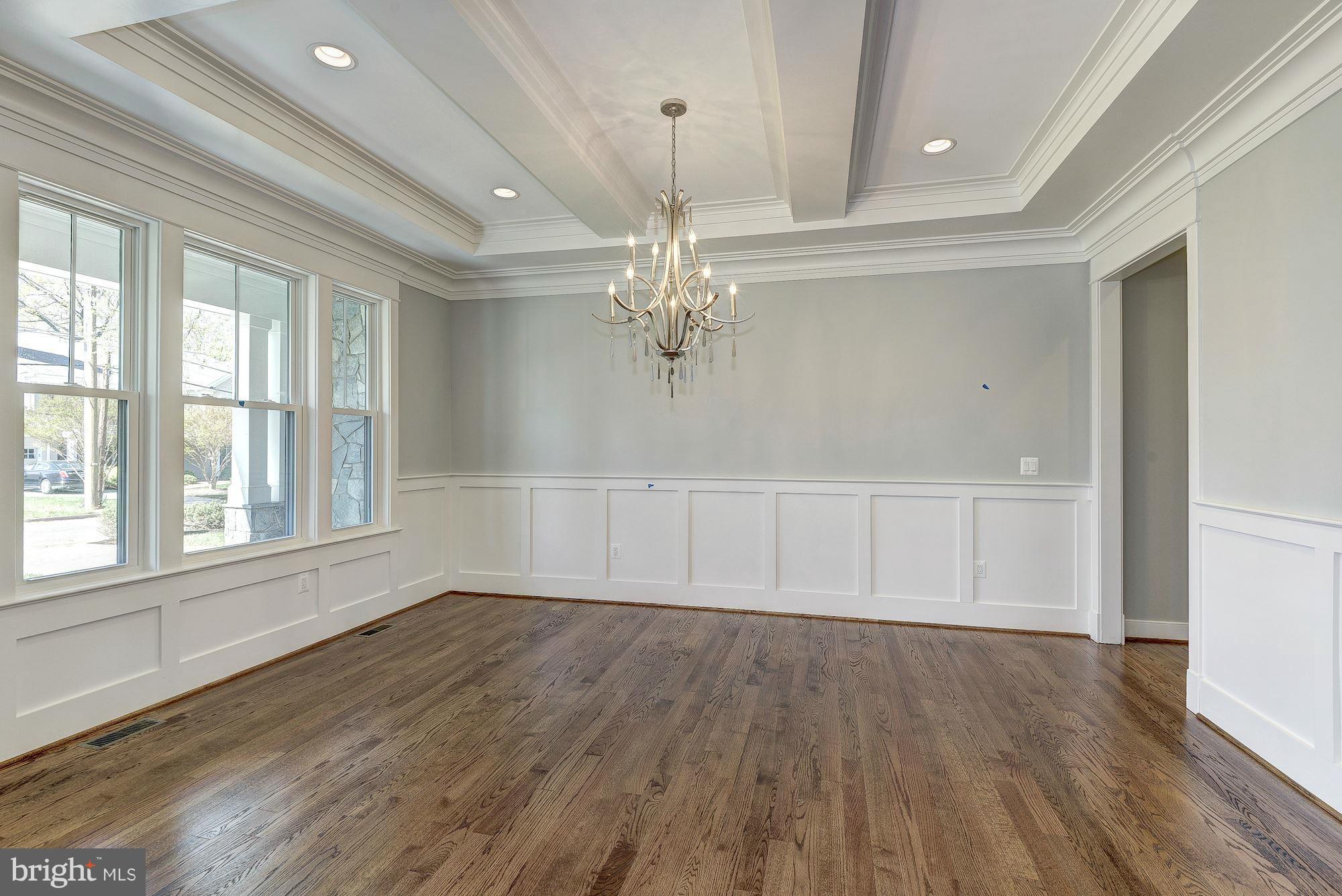 2108 Windsor Road Alexandria, VA 22307 - Photo 5 of 30 an empty room with wooden floor chandelier and windows