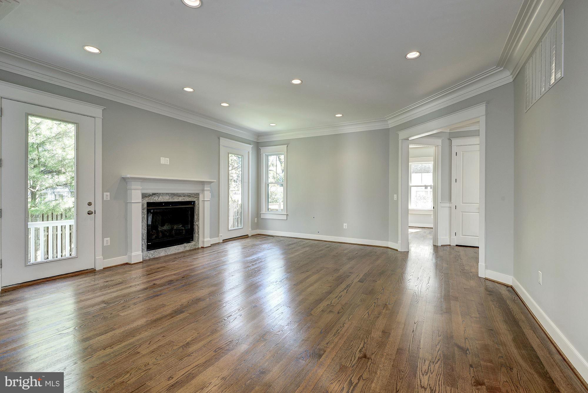 2108 Windsor Road Alexandria, VA 22307 - Photo 8 of 30 an empty room with wooden floor fireplace and windows