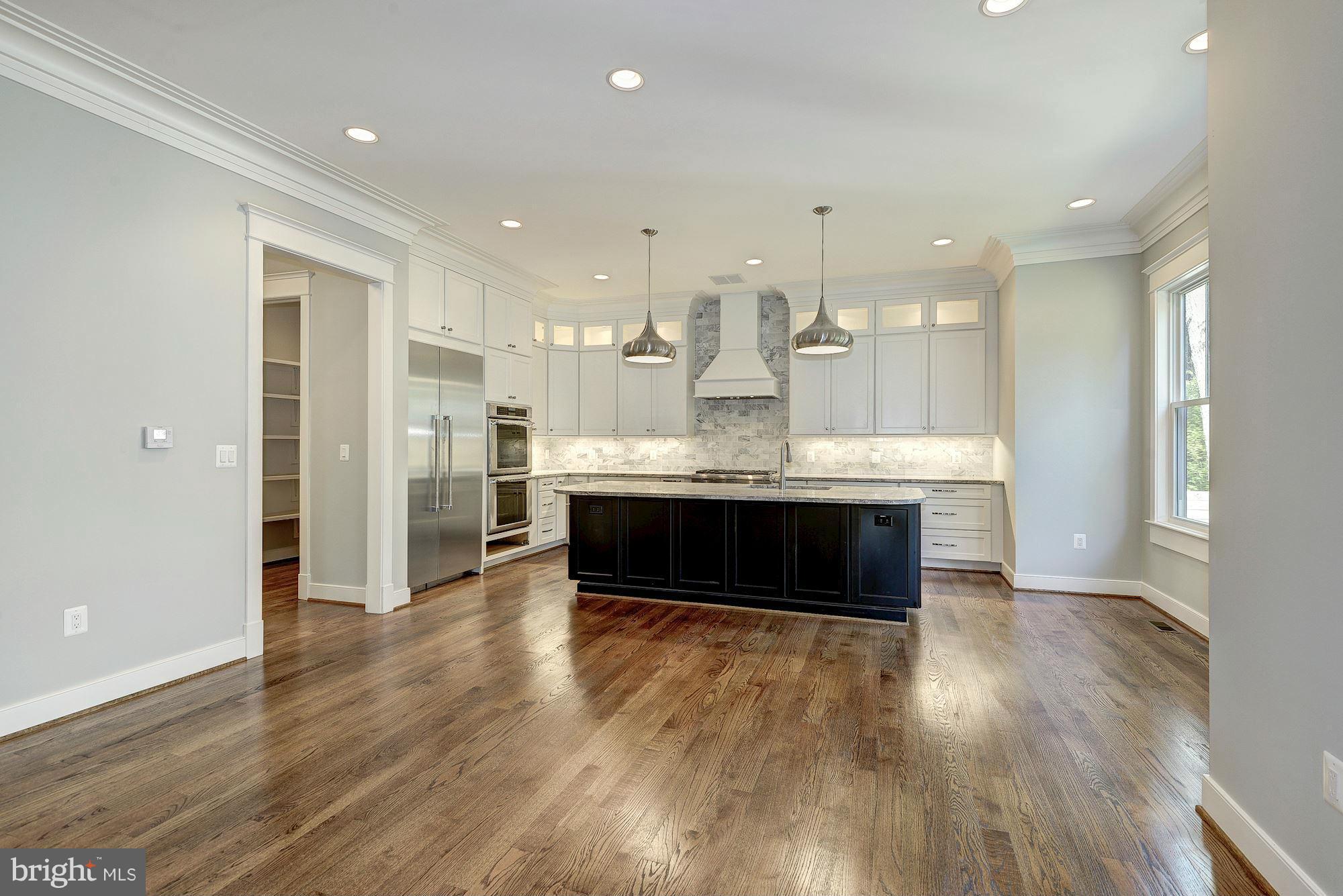 2108 Windsor Road Alexandria, VA 22307 - Photo 10 of 30 a living room with stainless steel appliances kitchen island hardwood floor and a kitchen