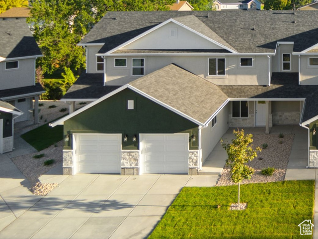 1615 North Angel Street, Unit E Layton, UT 84041 - Photo 1 of 42 View of front of house with stone siding, driveway, and a mountain view