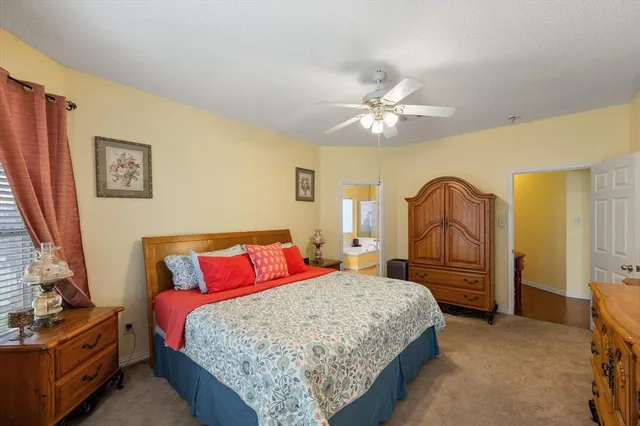 a bedroom with a bed dresser and a dining table