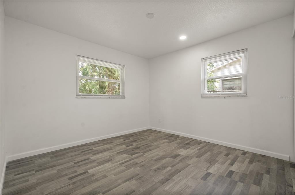 4385 Cassius Street Orlando, FL 32811 - Photo 18 of 21 a view of room with window and wooden floor