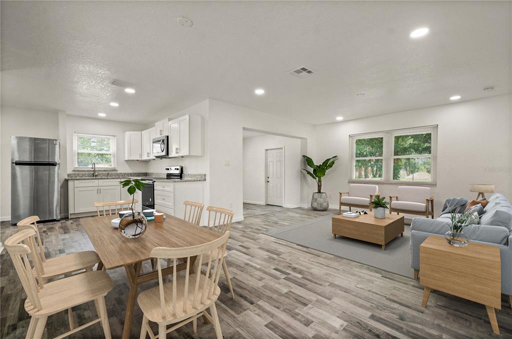 4385 Cassius Street Orlando, FL 32811 - Photo 5 of 21 a view of a dining room with furniture and wooden floor