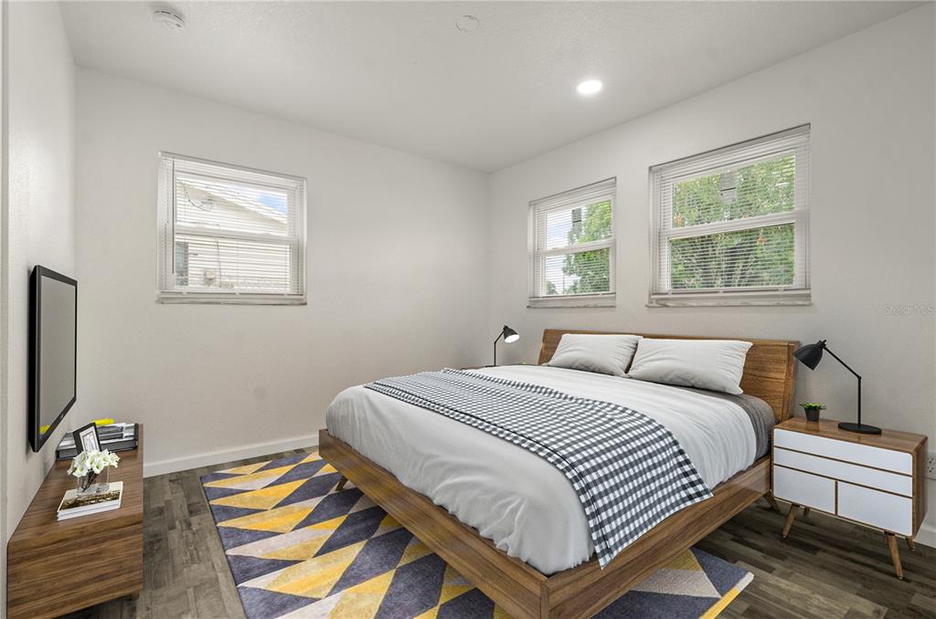 4385 Cassius Street Orlando, FL 32811 - Photo 7 of 21 a bedroom with a bed and windows