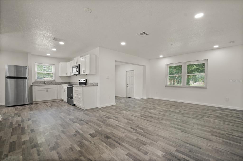 4385 Cassius Street Orlando, FL 32811 - Photo 10 of 21 a view of a kitchen with a sink hardwood floor and a large window