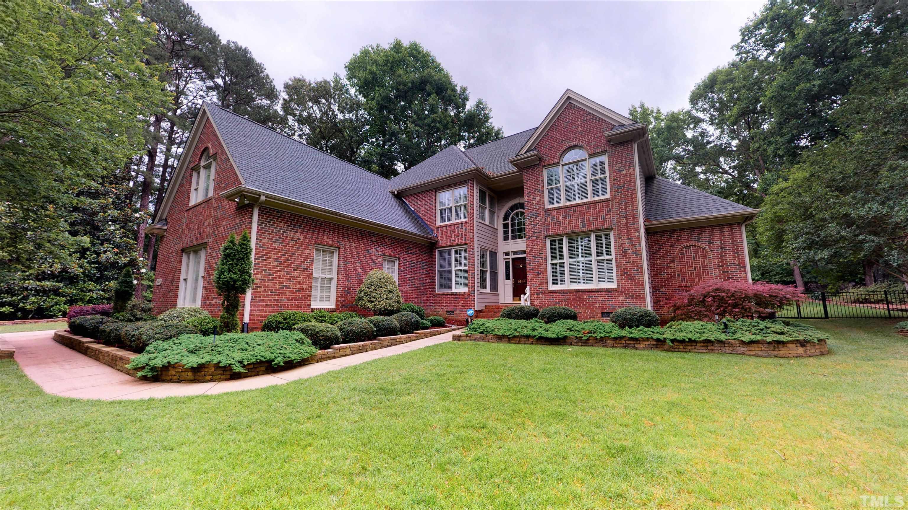 1624 Adams Mountain Road Raleigh, NC 27614 - Photo 1 of 100 a front view of a house with a yard and garage
