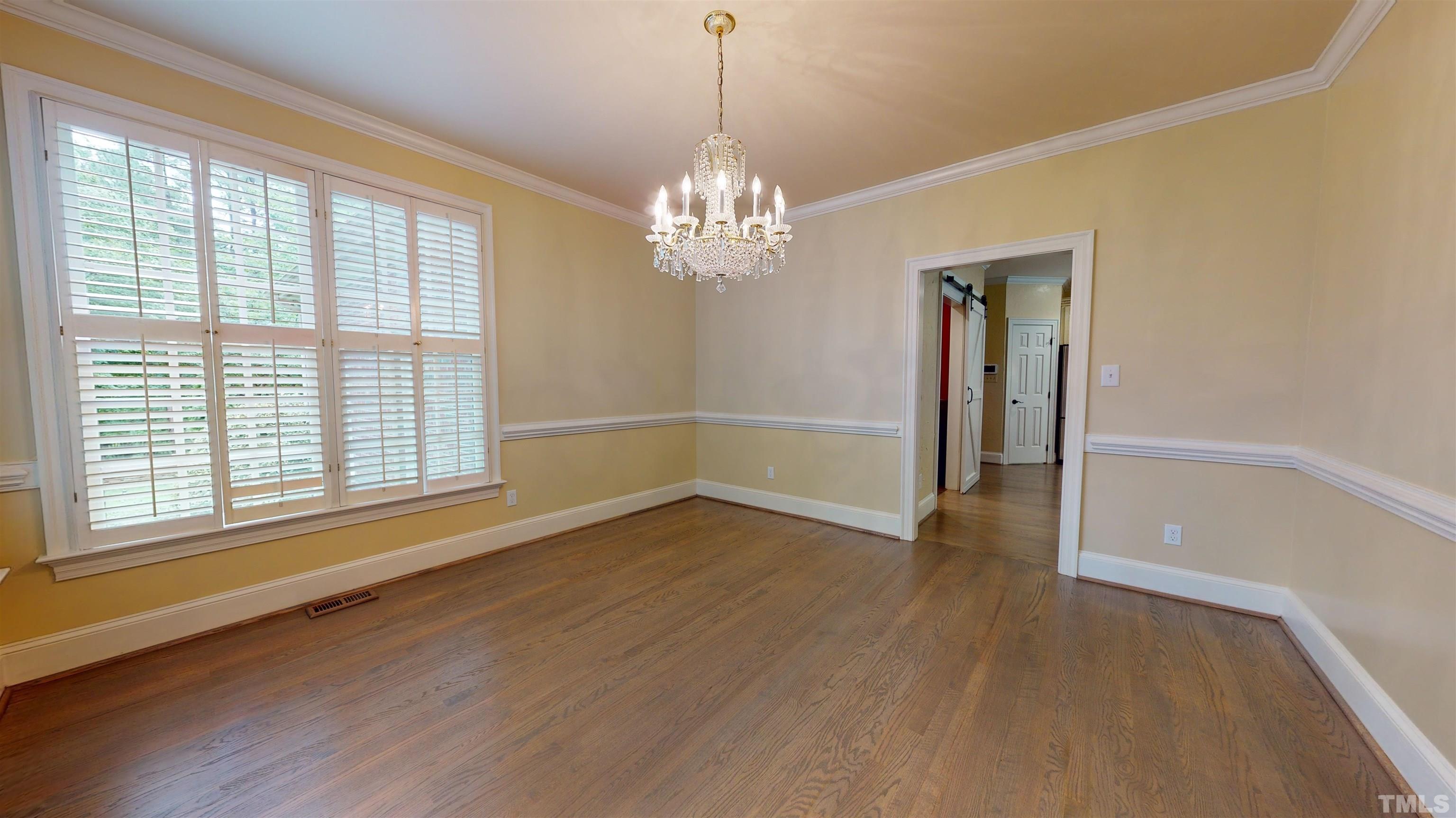 1624 Adams Mountain Road Raleigh, NC 27614 - Photo 12 of 100 a view of an empty room with a window and wooden floor