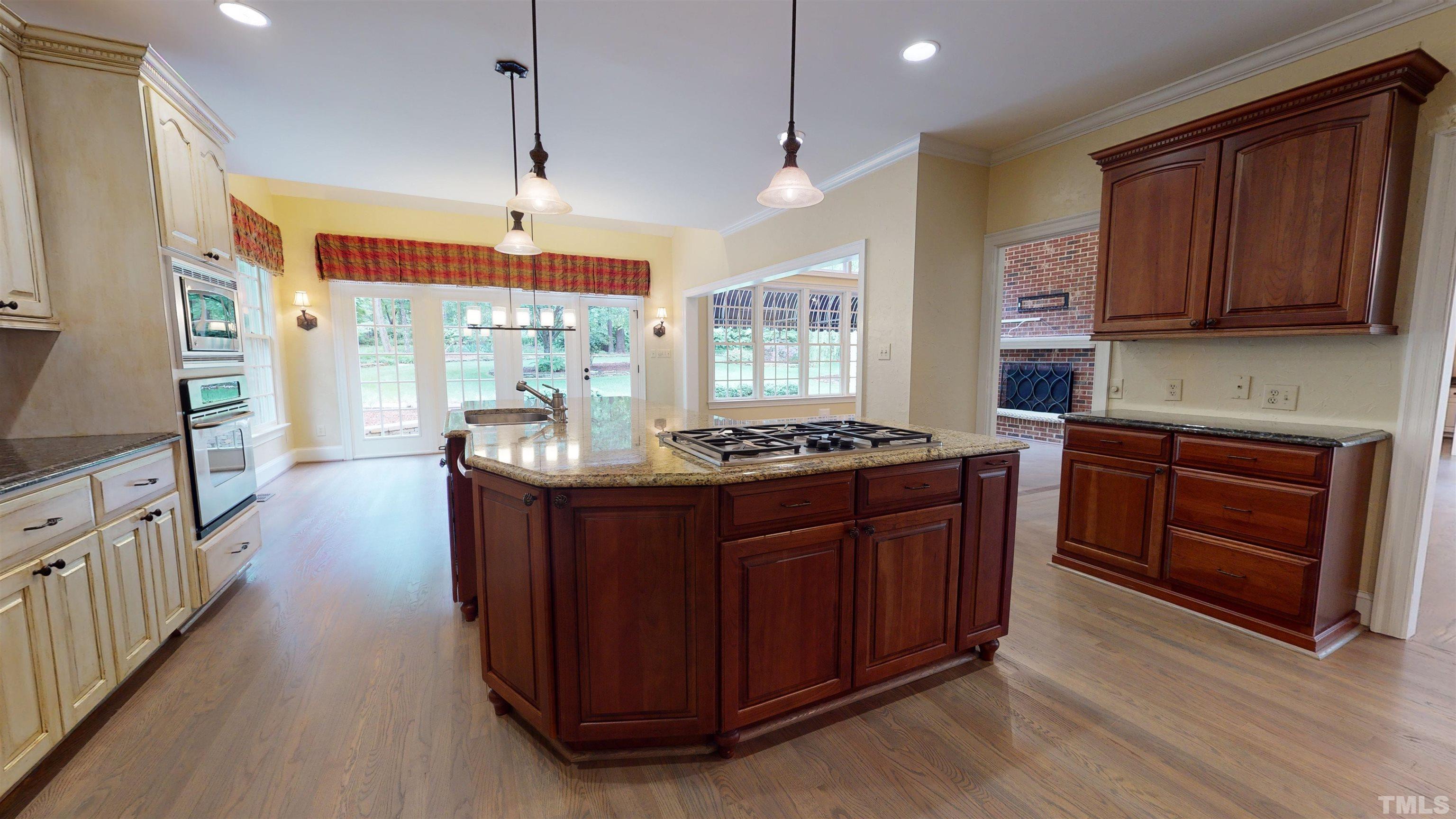1624 Adams Mountain Road Raleigh, NC 27614 - Photo 18 of 100 a kitchen with granite countertop a stove and a wooden cabinets