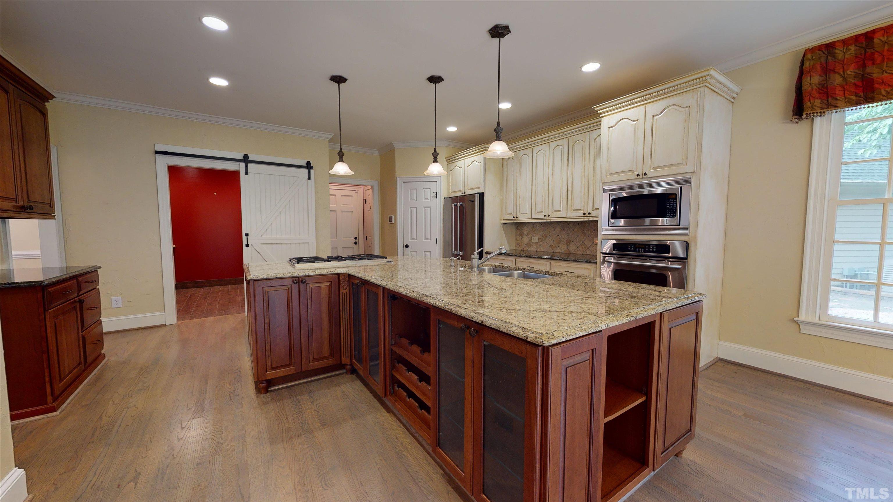 1624 Adams Mountain Road Raleigh, NC 27614 - Photo 26 of 100 a kitchen with kitchen island granite countertop a stove oven a sink dishwasher and a oven with wooden floor