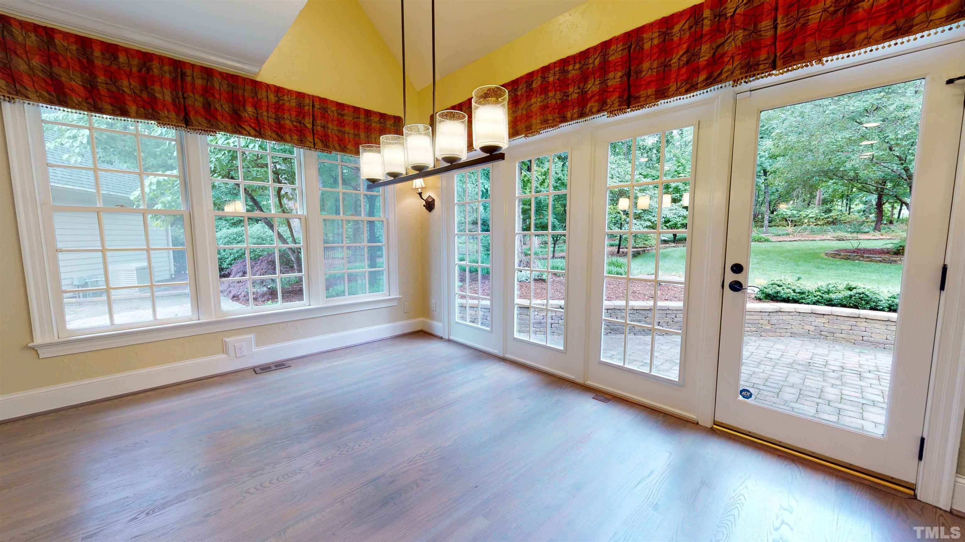 1624 Adams Mountain Road Raleigh, NC 27614 - Photo 27 of 100 a view of an empty room with wooden floor and a window