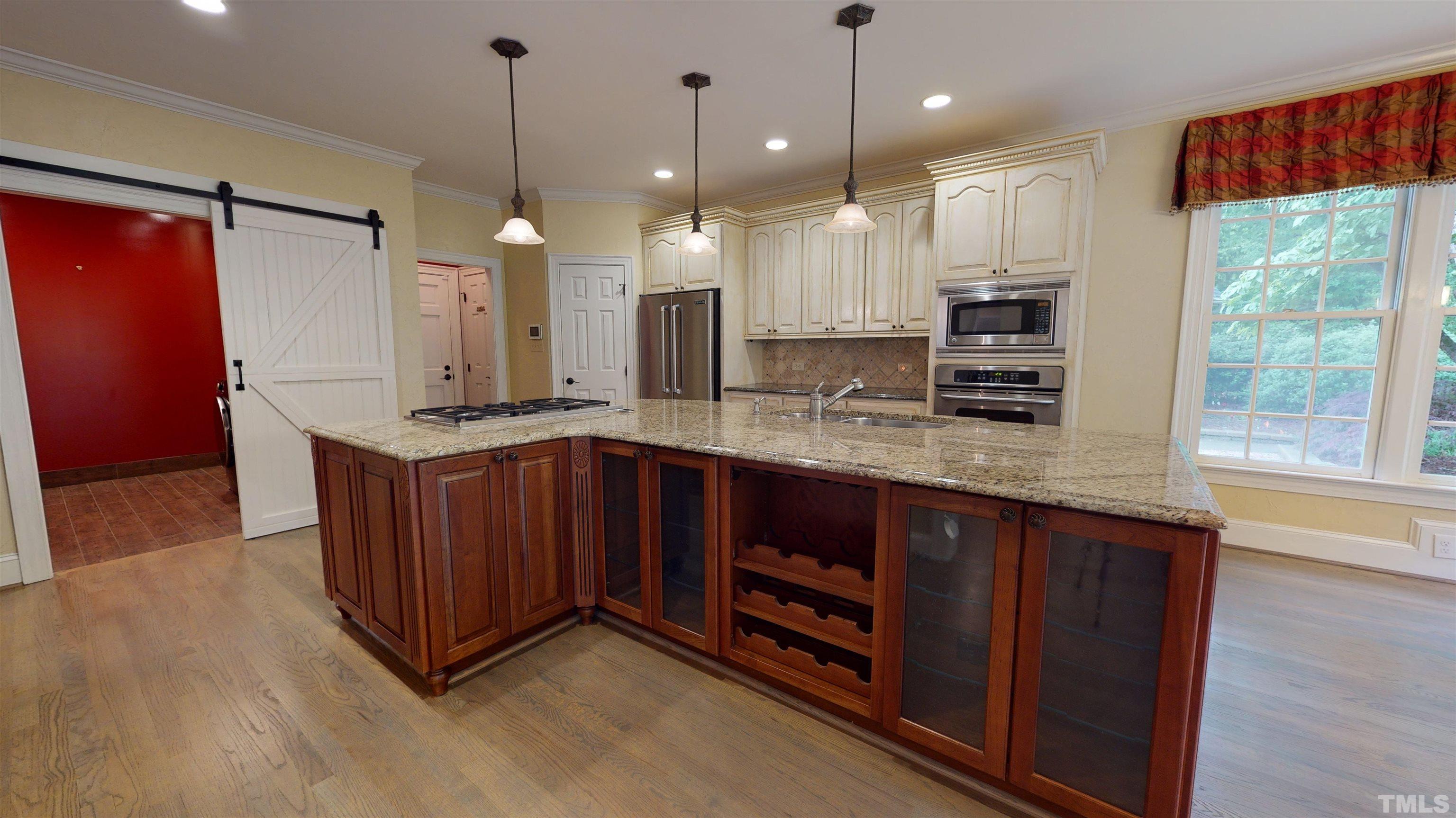 1624 Adams Mountain Road Raleigh, NC 27614 - Photo 29 of 100 a kitchen with stainless steel appliances granite countertop a stove a sink and a refrigerator with wooden floor