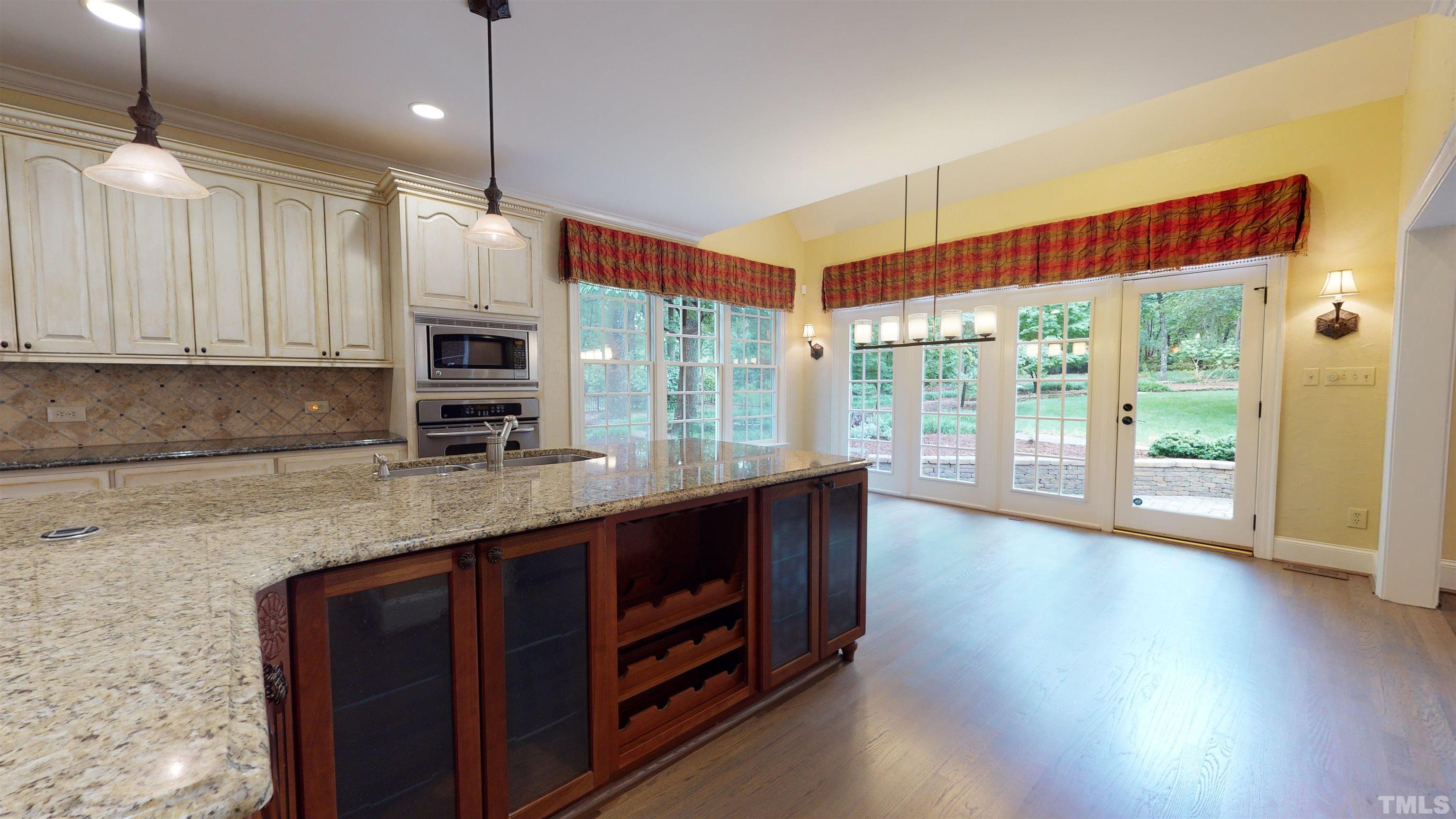1624 Adams Mountain Road Raleigh, NC 27614 - Photo 33 of 100 a kitchen with stainless steel appliances granite countertop a stove a sink and a refrigerator with wooden floor