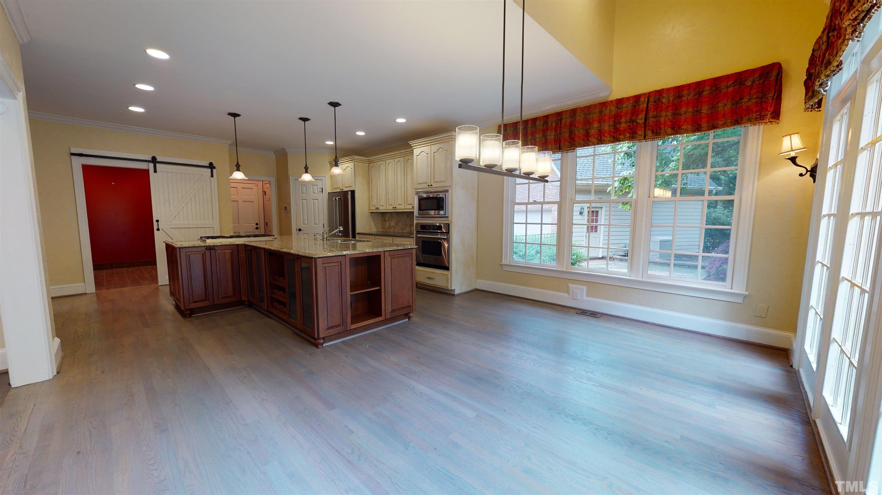 1624 Adams Mountain Road Raleigh, NC 27614 - Photo 36 of 100 a open kitchen with stainless steel appliances granite countertop a refrigerator oven a sink dishwasher and wooden cabinets with wooden floor