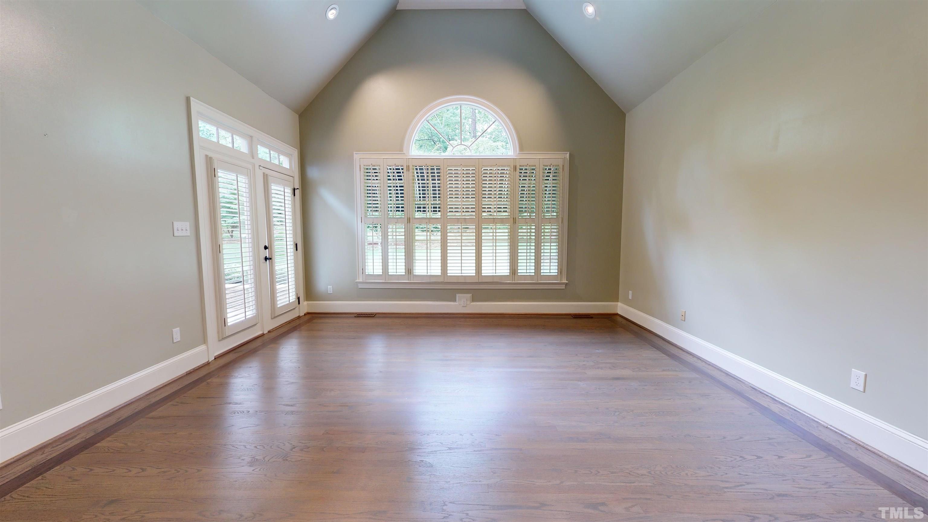 1624 Adams Mountain Road Raleigh, NC 27614 - Photo 50 of 100 an empty room with wooden floor and windows