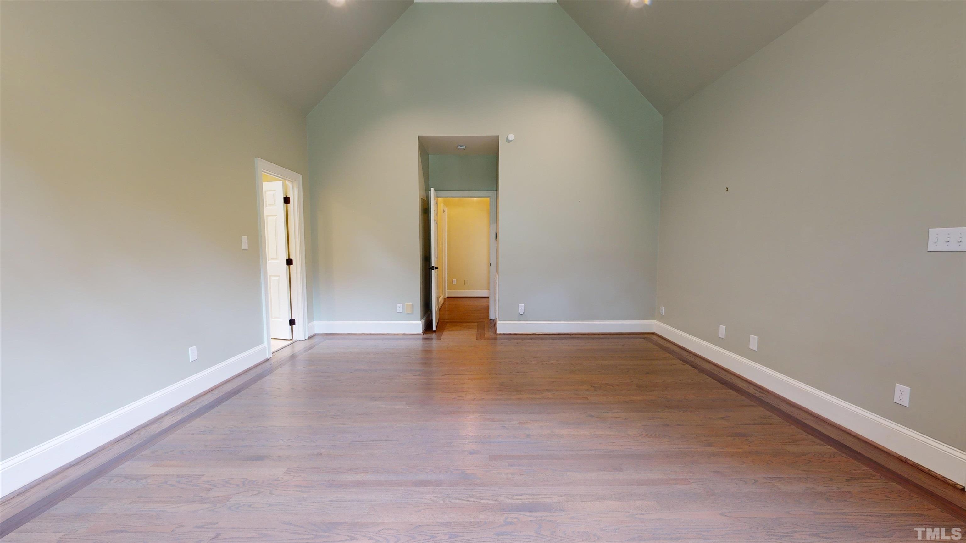 1624 Adams Mountain Road Raleigh, NC 27614 - Photo 53 of 100 a view of an empty room with wooden floor and a window