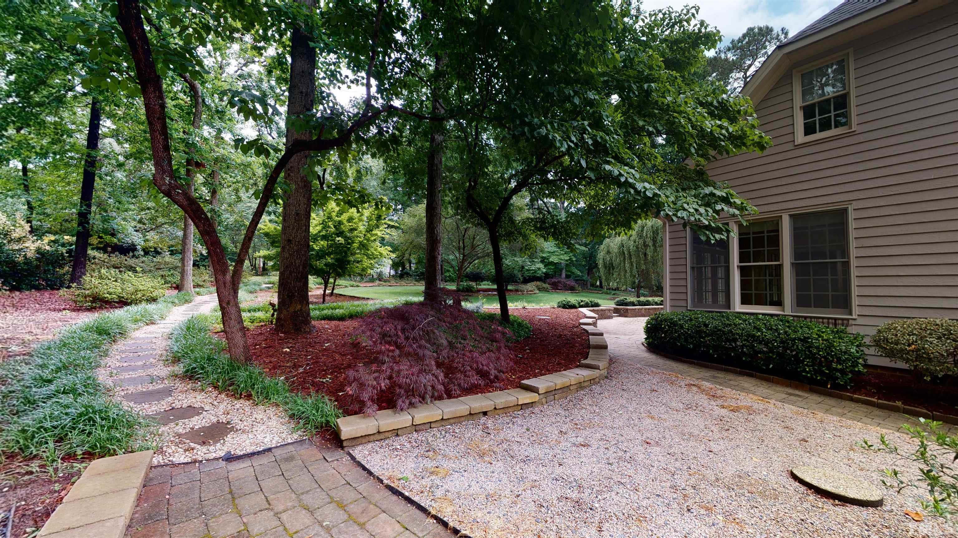 1624 Adams Mountain Road Raleigh, NC 27614 - Photo 82 of 100 a view of a backyard with potted plants and large trees