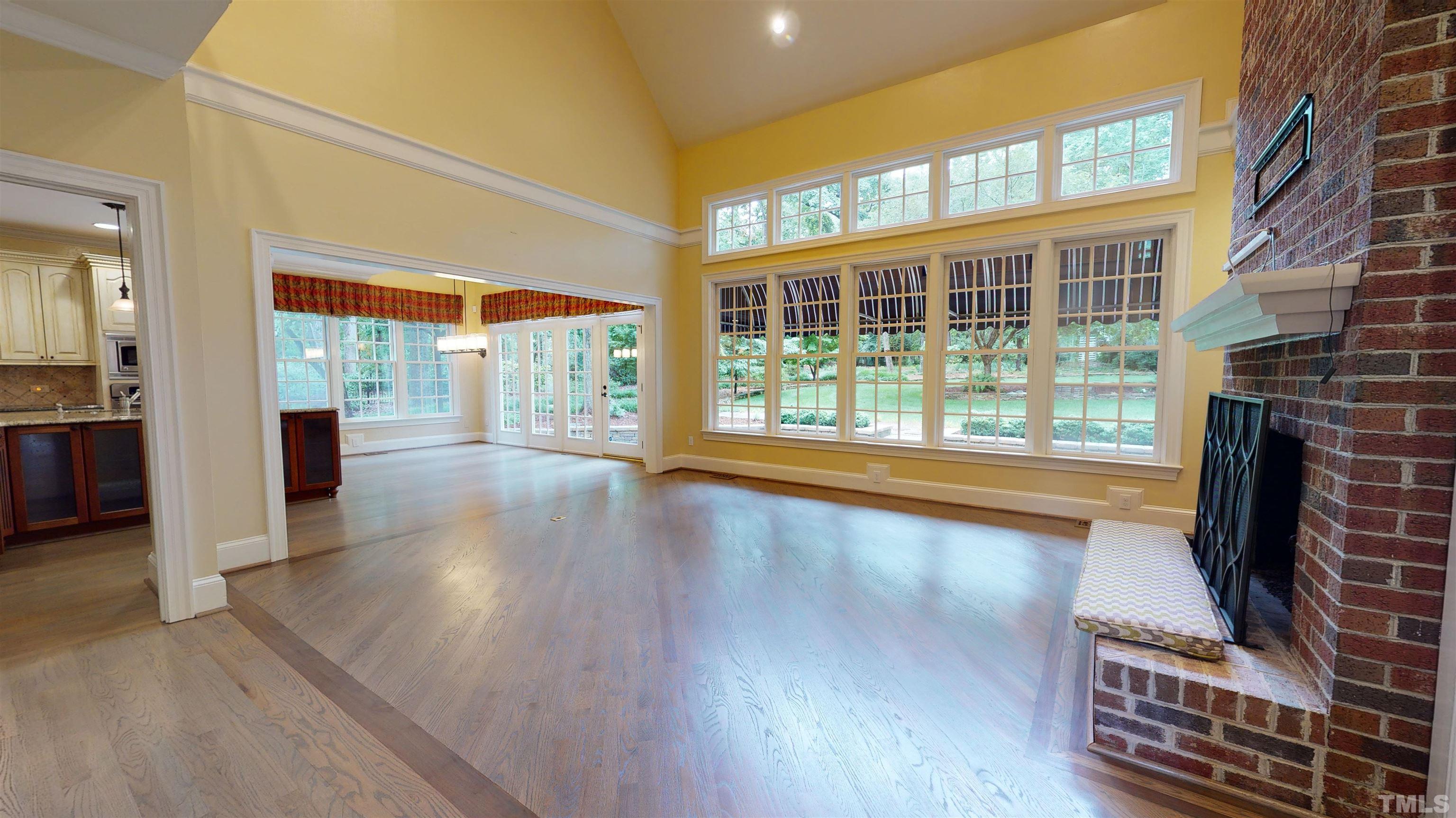 1624 Adams Mountain Road Raleigh, NC 27614 - Photo 10 of 100 wooden floor in an empty room with a fireplace