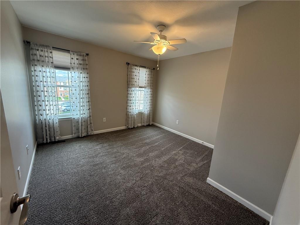 202 Pointe View Drive Mars, PA 16046 - Photo 8 of 10 an empty room with windows and chandelier fan