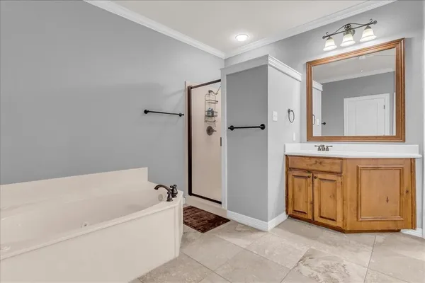 a bathroom with a tub sink and mirror
