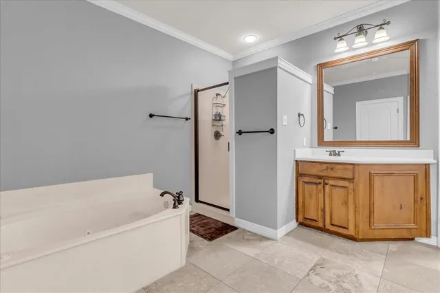 a bathroom with a tub sink and mirror