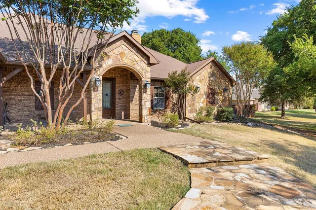 a view of a house with snow on the road