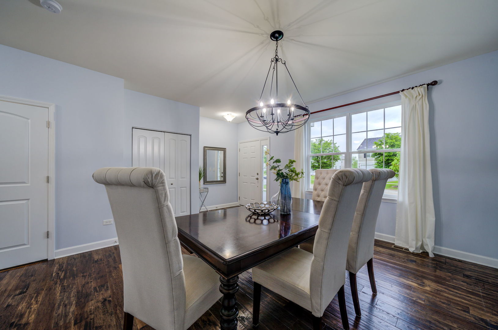 2305 Brookstone Drive Bolingbrook, IL 60490 - Photo 3 of 26 a view of a dining room with furniture a chandelier and wooden floor