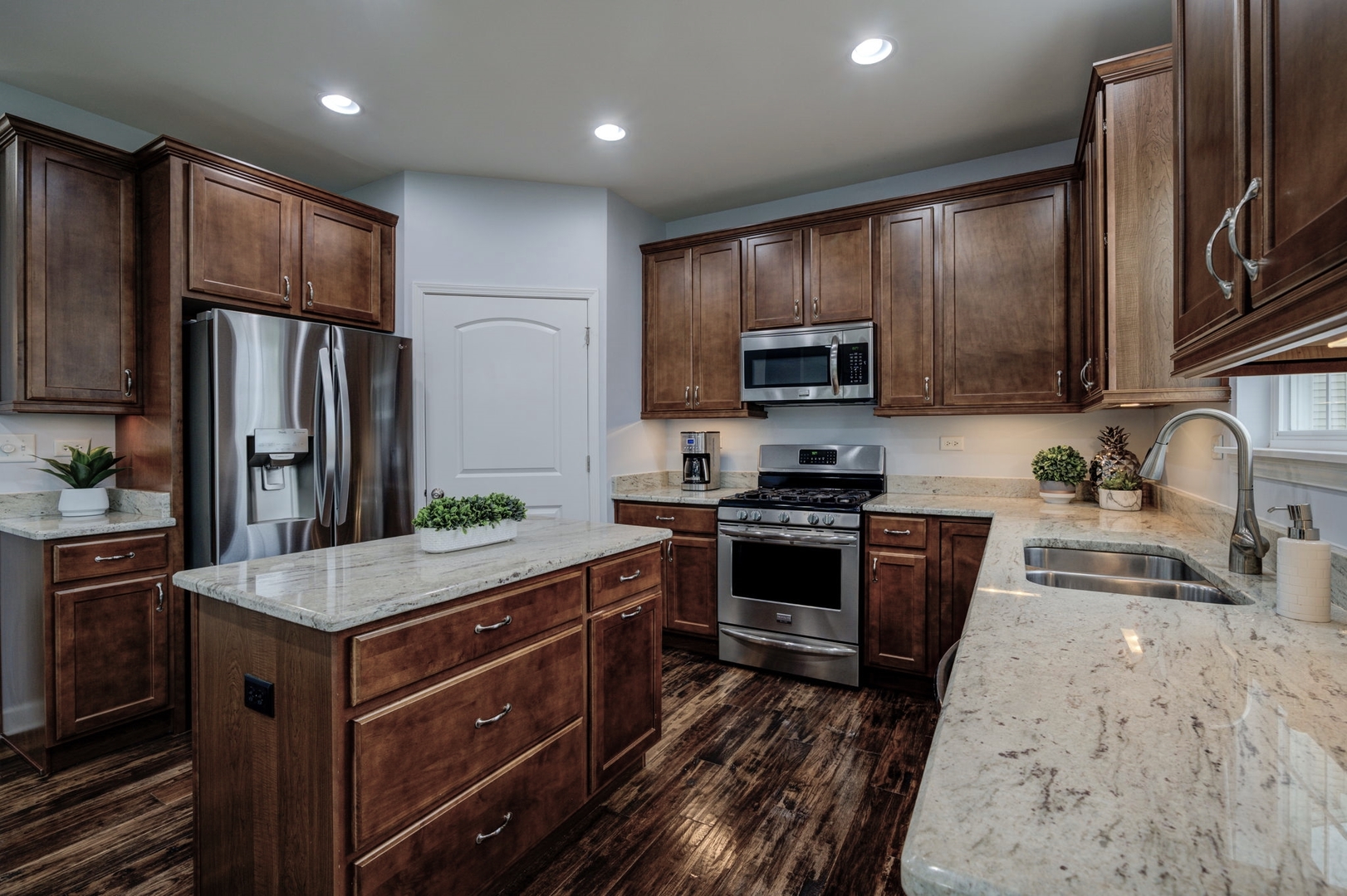 2305 Brookstone Drive Bolingbrook, IL 60490 - Photo 4 of 26 a kitchen with kitchen island granite countertop stainless steel appliances and wooden cabinets