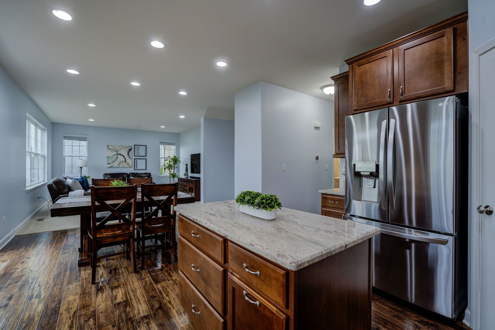 2305 Brookstone Drive Bolingbrook, IL 60490 - Photo 6 of 26 a kitchen with stainless steel appliances granite countertop a table chairs and a refrigerator
