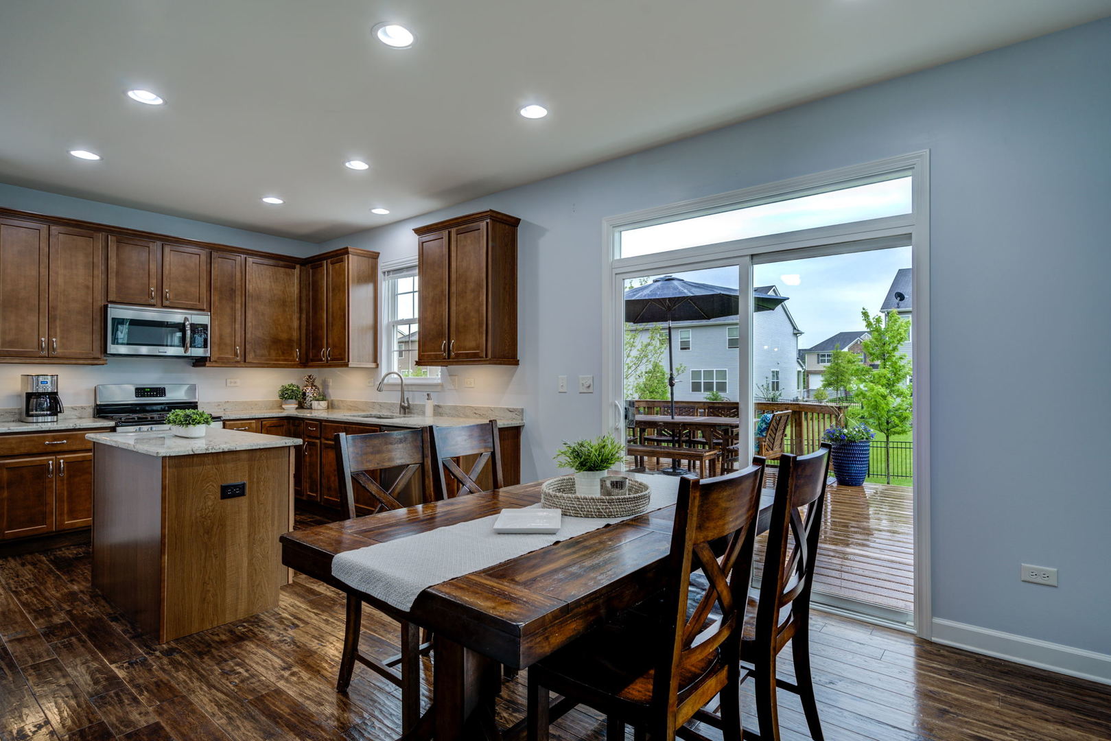 2305 Brookstone Drive Bolingbrook, IL 60490 - Photo 7 of 26 a kitchen with stainless steel appliances granite countertop wooden cabinets a refrigerator a stove a microwave oven a dining table and chairs