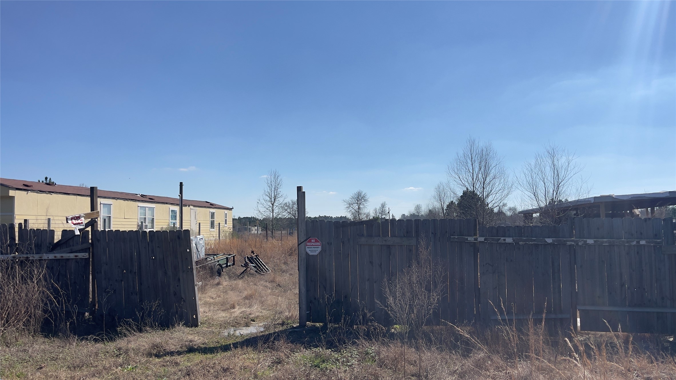 905 County Road 5023 Cleveland, TX 77327 - Photo 5 of 6 a view of a house with a backyard